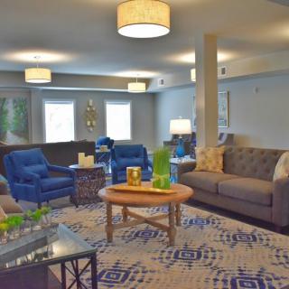 Spacious living room with modern furniture and decor.
