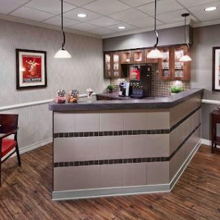 A modern reception area featuring a sleek counter and cozy seating arrangements.