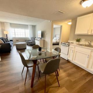 Modern open-plan apartment with kitchen, dining area, and living room.