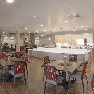 A modern restaurant dining area with neatly arranged tables and chairs.