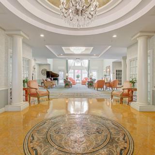 Luxurious hotel lobby with elegant decor and a grand piano.