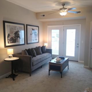 A cozy living room featuring a comfortable sofa, coffee table, and elegant lighting.