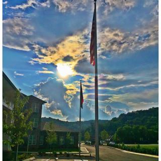 A scenic view of flags against a vibrant sunset sky.