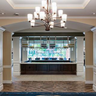 A stylish hotel lobby featuring a modern reception desk and elegant chandelier.