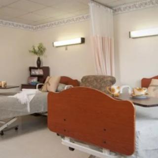 A tranquil hospital room with multiple patient beds and a minimalistic design.