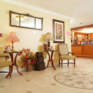 A warmly decorated hotel lobby with comfortable seating and a welcoming reception area.