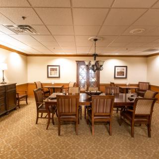 A cozy dining room with wooden furniture and a chandelier.