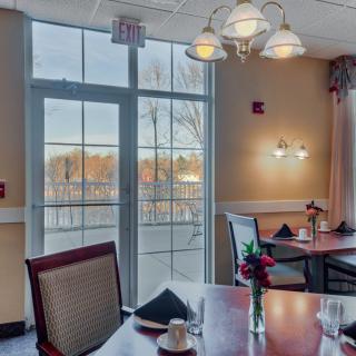 A cozy restaurant dining area with elegant lighting and a window view.