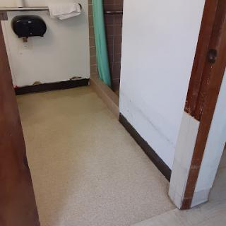 A view of the floor and door area in a bathroom.