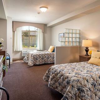 A cozy bedroom with twin beds, decorated in a warm and inviting style.