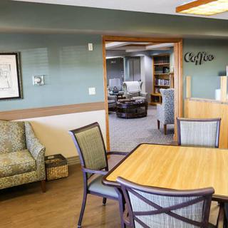 A comfortable lobby area with a table, chairs, and reception desk.
