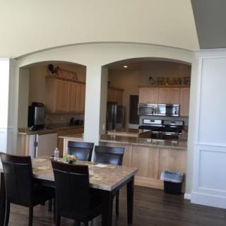 A modern kitchen and dining area featuring an open layout with wooden furnishings.
