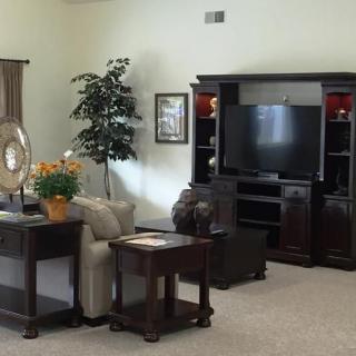 A cozy living room with a television, sofa, and stylish furniture arrangement.