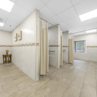 A clean and modern interior of a medical clinic featuring a waiting area and private consultation spaces.
