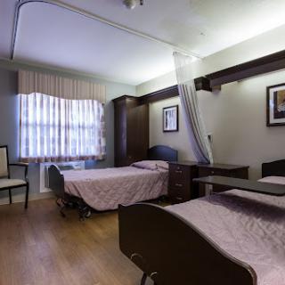 A well-appointed hospital room featuring two patient beds, designed for comfort and functionality.