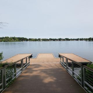 A peaceful view of a lake from a wooden dock.
