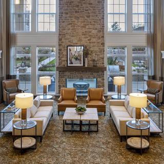 Modern living room with stylish furniture and a cozy fireplace.