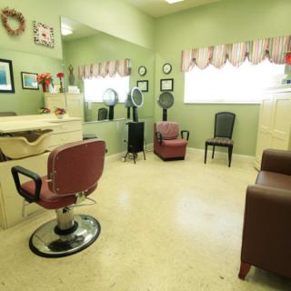 A vintage-style salon with chairs, mirrors, and hairdressing equipment.