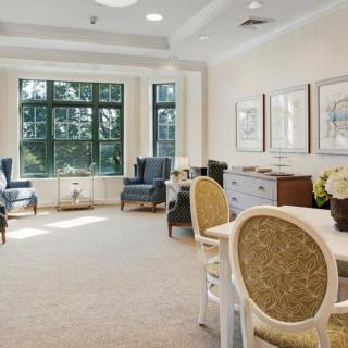 A spacious and well-lit living area with comfortable seating and large windows.