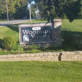 Entrance sign for Woodside Village, a residential community.