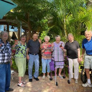 A group of seniors enjoying a day out in a tropical setting.