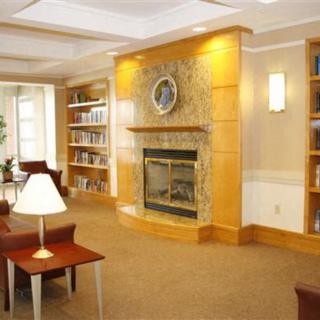 A cozy library interior with a fireplace and bookshelves.