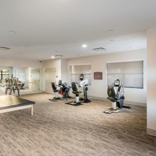 A modern fitness center featuring exercise equipment and training machines.