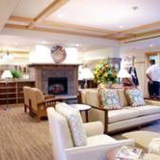 A cozy living room with a fireplace and comfortable seating.