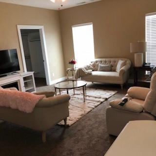 A cozy living room with sofas, a TV, and a coffee table.
