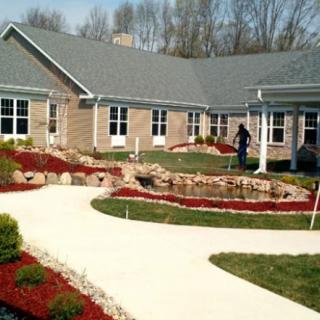 A modern house with well-maintained landscaping and a winding pathway.