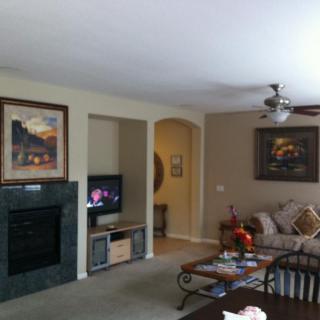A cozy living room with a fireplace, television, and comfortable seating.