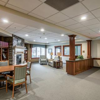 A spacious lobby with comfortable seating, wood accents, and a warm atmosphere.