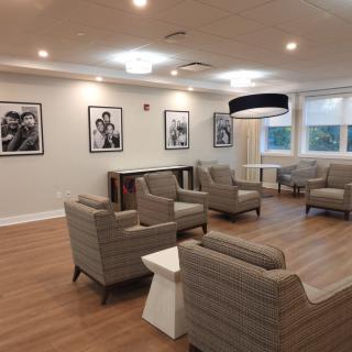A modern lounge area with comfortable seating and framed artwork on the walls.