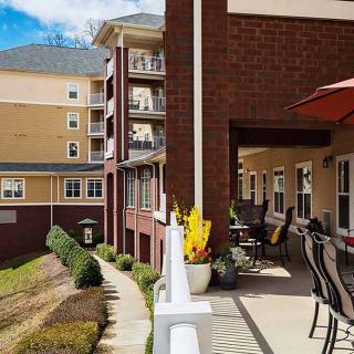 A view of a residential building with balconies and outdoor seating areas.