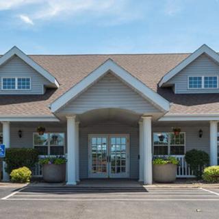 A suburban-style building with a symmetrical front entrance and columns.