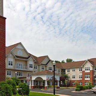 A suburban residential building under a cloudy sky.