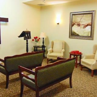 A serene waiting room with comfortable seating, warm lighting, and decorative artwork.
