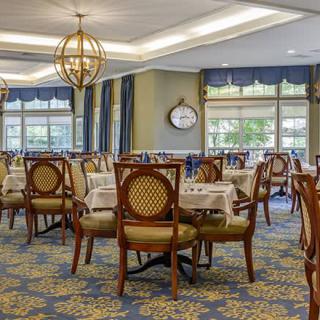 An elegantly decorated dining room with tables and chairs arranged for patrons.