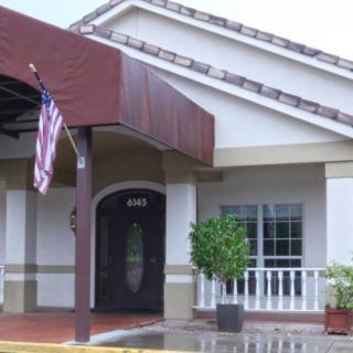 Entrance to a building with an American flag and awning.