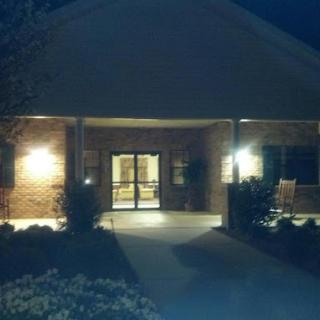 The illuminated entrance of a building at night, providing a welcoming atmosphere.