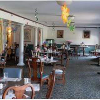 An elegant restaurant dining room with neatly arranged tables and chairs.