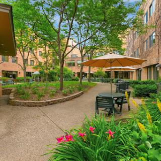 A serene courtyard filled with greenery and seating areas, perfect for relaxation.