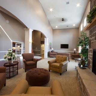 A spacious and elegantly designed living room with comfortable seating, a fireplace, and modern decor.