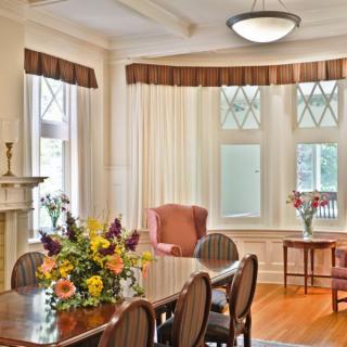 A beautifully furnished dining room with elegant decor and a large table set for gathering.