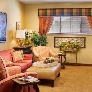 A cozy living room with colorful decor and comfortable seating.