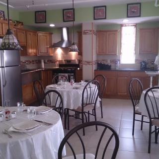 A cozy dining area with round tables set in a kitchen environment.