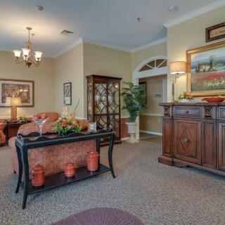 A traditionally styled living room featuring classic furniture and decor with warm lighting.