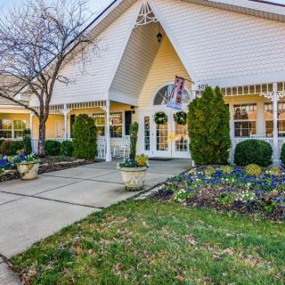 Front view of a residential house with well-maintained landscaping and a spacious entrance.