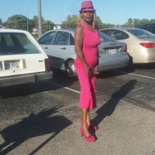 Stylishly dressed in a vibrant pink outfit, ready to shine on a sunny day.