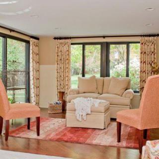 A cozy living room with elegant furniture and large windows providing natural light.